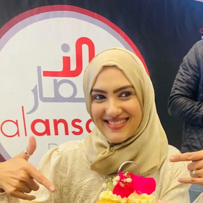 Razia laughing at the Radio Al-Ansaar studio